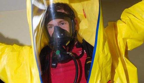 Firefighter wearing a protective suit